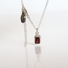 Load image into Gallery viewer, A silver 925 necklace with a square red garnet pendant and a small silver medallion on a chain.