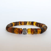 Load image into Gallery viewer, A bracelet made of natural amber beads with a silver 925 accent bead featuring a spiral design, displayed against a white background.