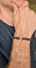 Load image into Gallery viewer, Close-up of a person wearing a bracelet on their wrist.