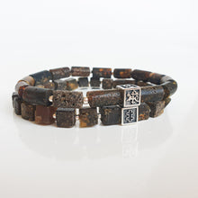 Load image into Gallery viewer, Stack of dark beaded bracelets with a silver clasp on a white background