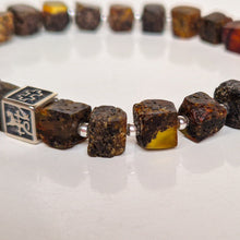 Load image into Gallery viewer, Close-up of a bracelet with brown beads on a white background