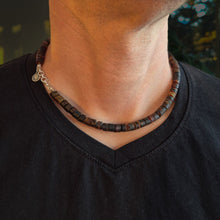 Load image into Gallery viewer, Person wearing a dark beaded Baltic amber necklace with silver