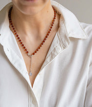 Load image into Gallery viewer, Person wearing a white shirt with a red amber beaded necklace